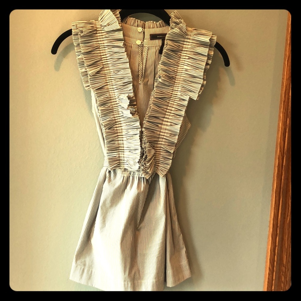 Black and white striped top with a ruffled neck.